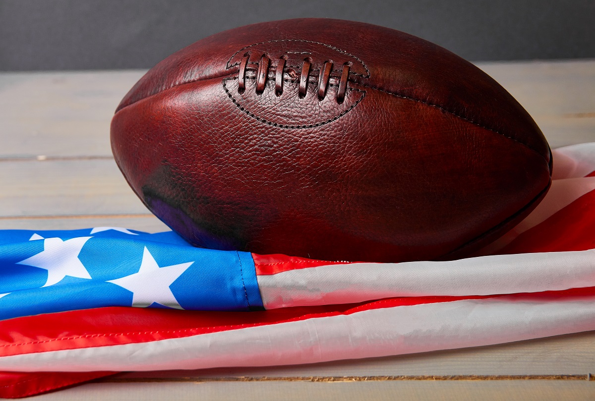 Antique American football and the US flag
