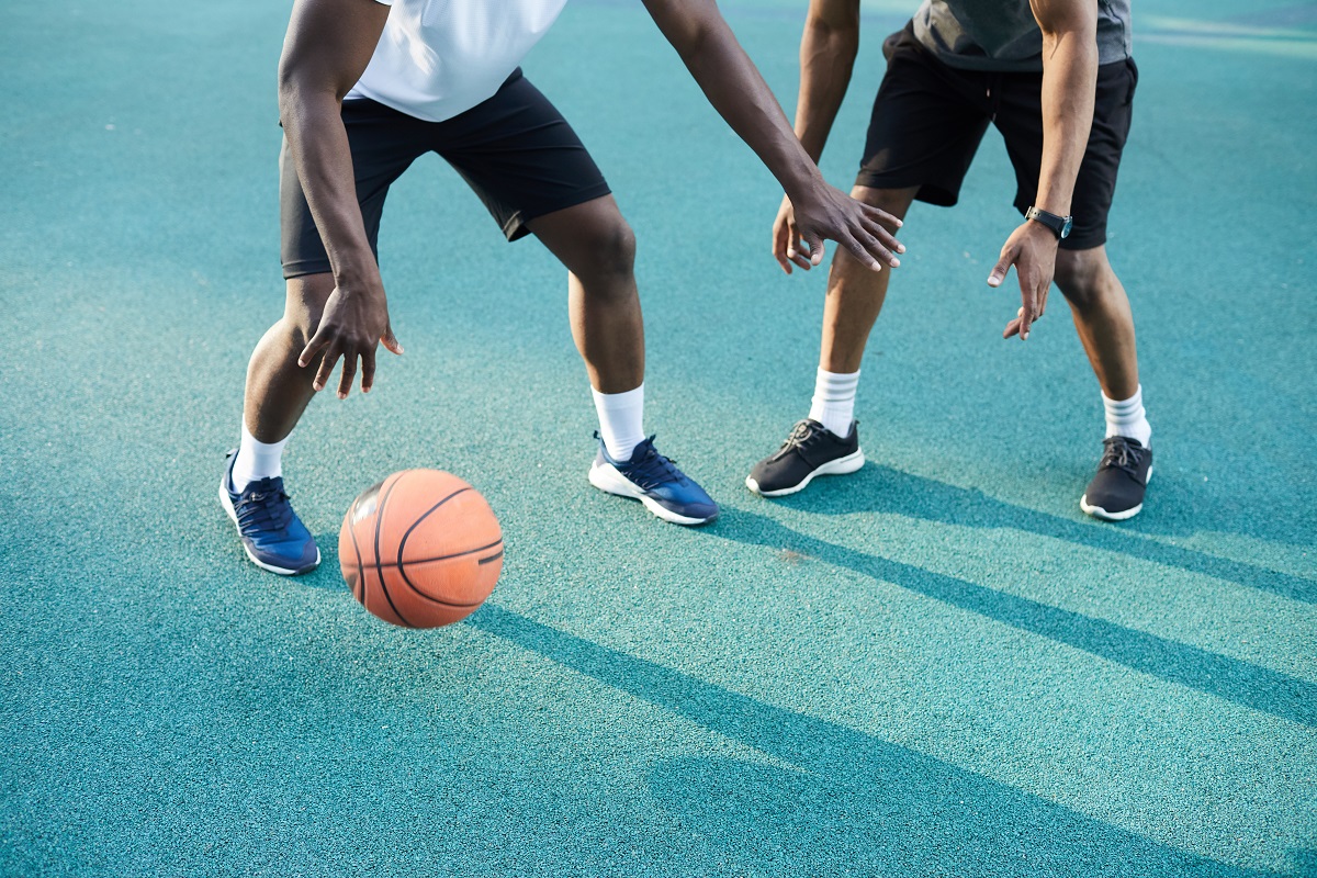 Two people playing basketball