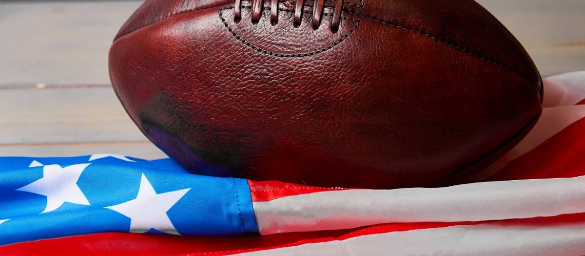 Antique American football and the US flag