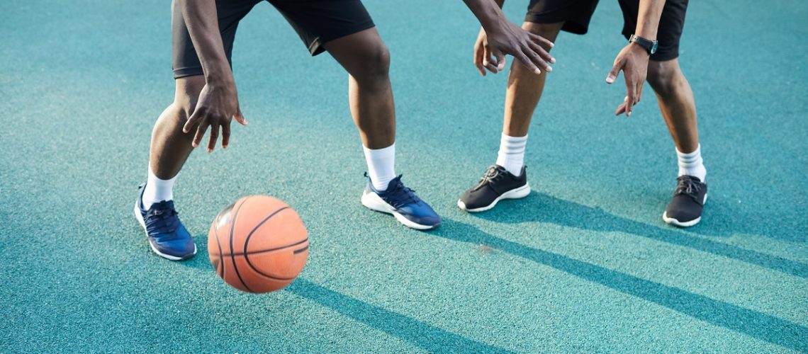 Two people playing basketball