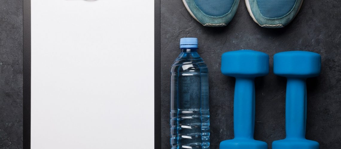 Clipboard, water bottle, weights, and sneakers