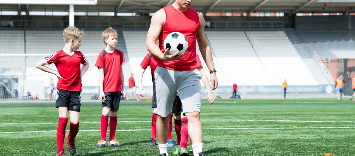 Soccer coach with players.