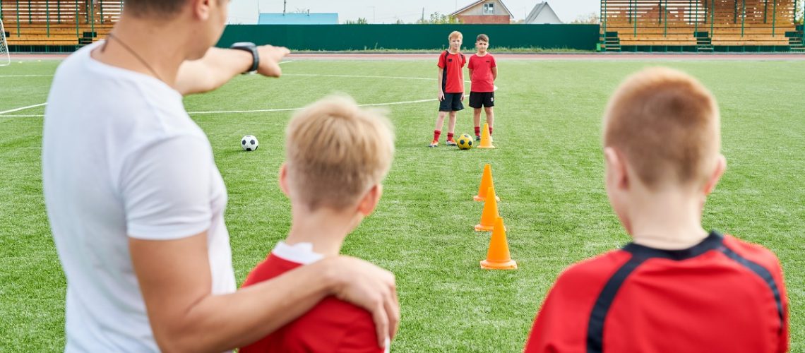 Coach with soccer players