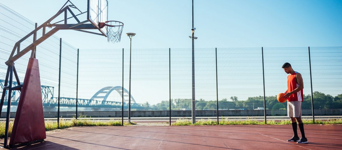 Young male basketball player taking a free throw.