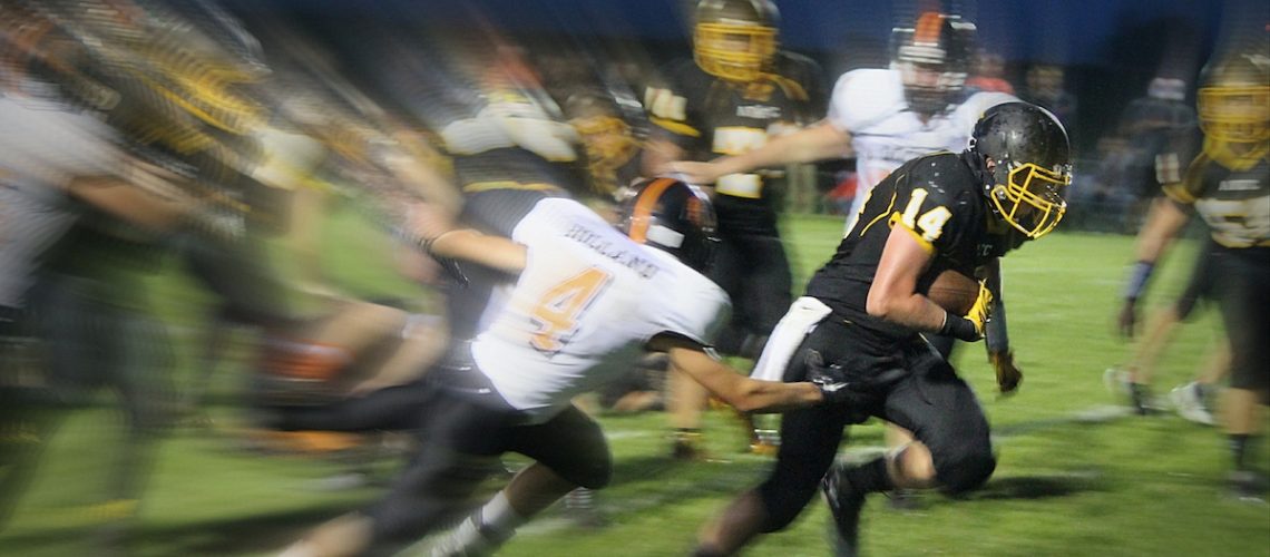 Image of football players with motion blur