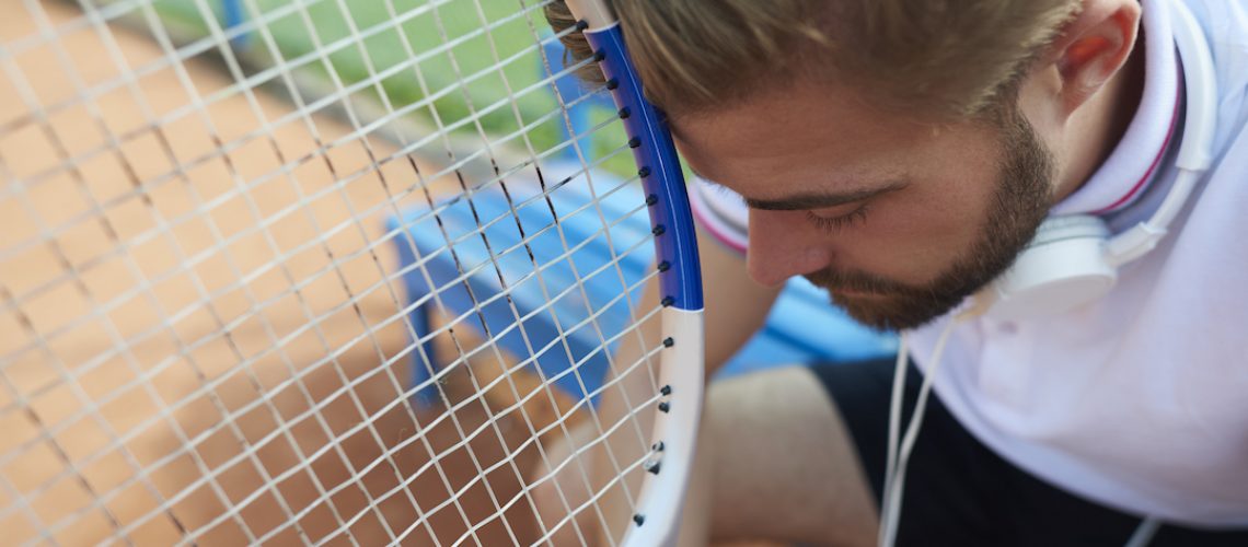 Tennis player quietly meditates