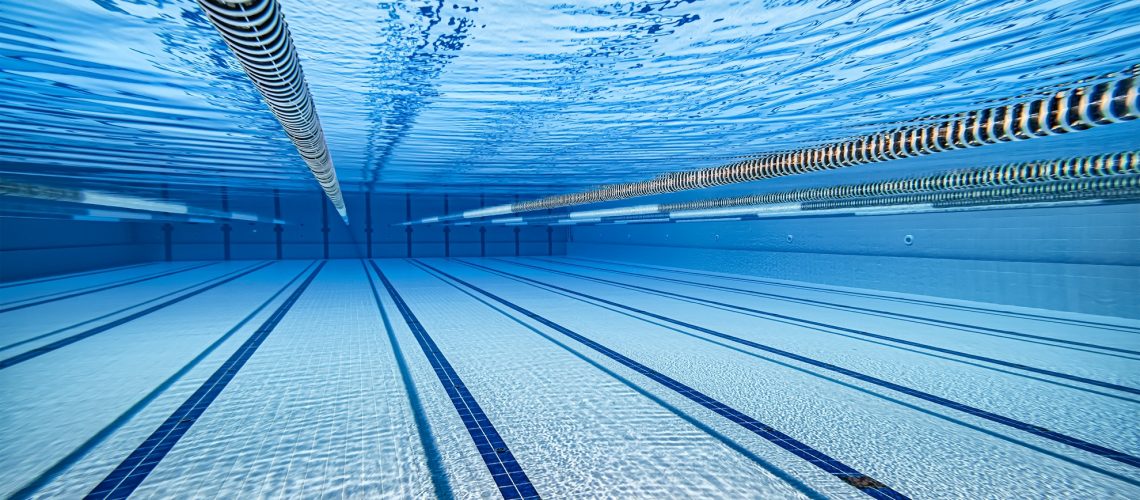 Olympic Swimming pool under water background.