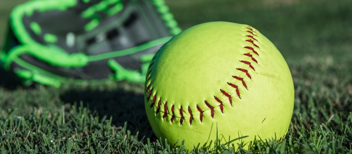 Softball and glove on a field