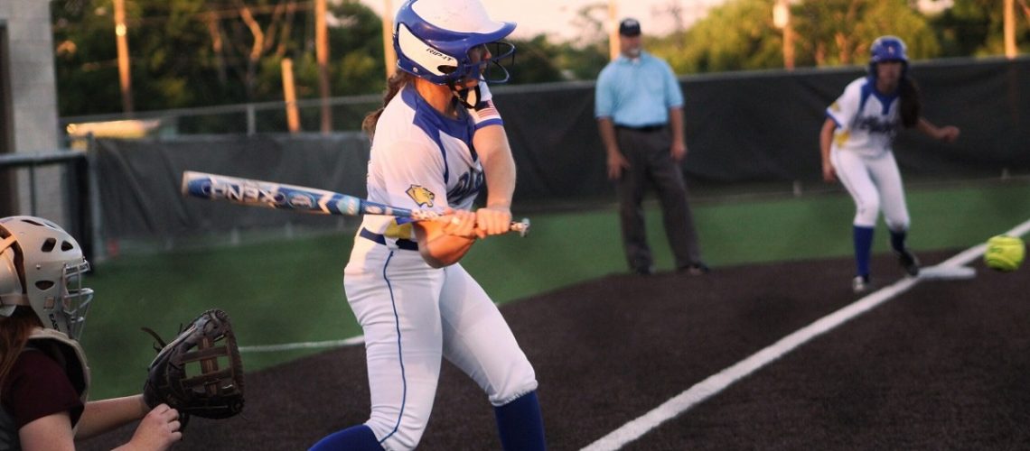 Softball player mid-swing