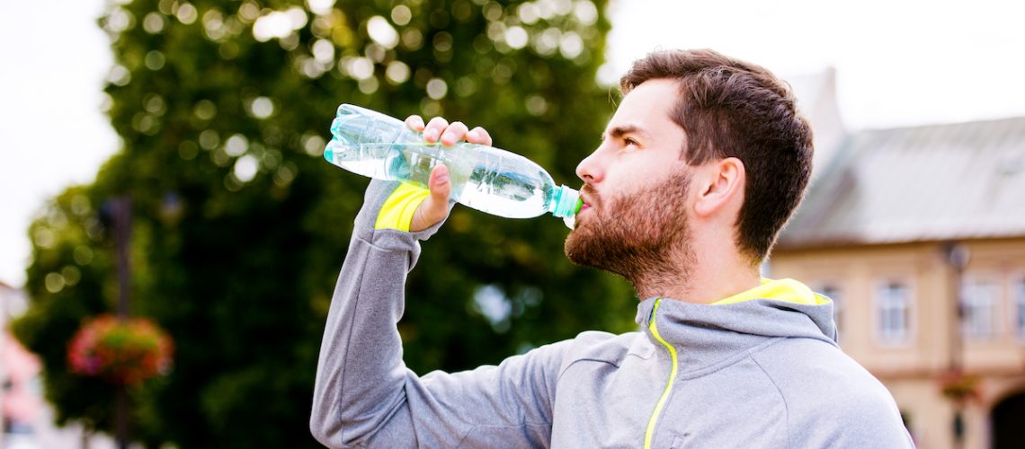 Runner enjoys water from a bottle