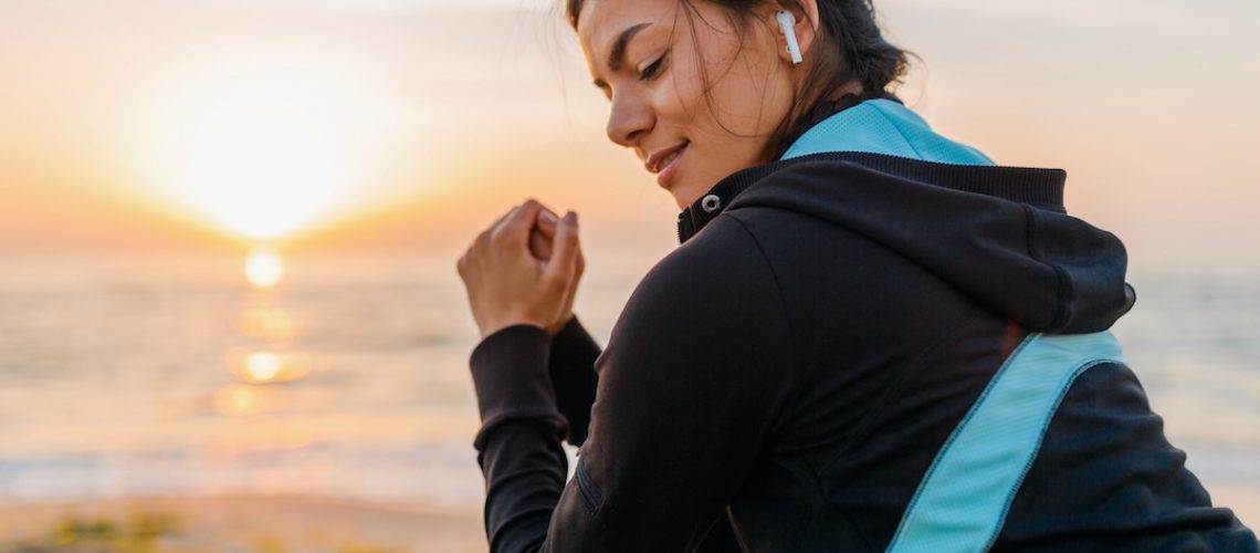 Exercising woman with earbuds