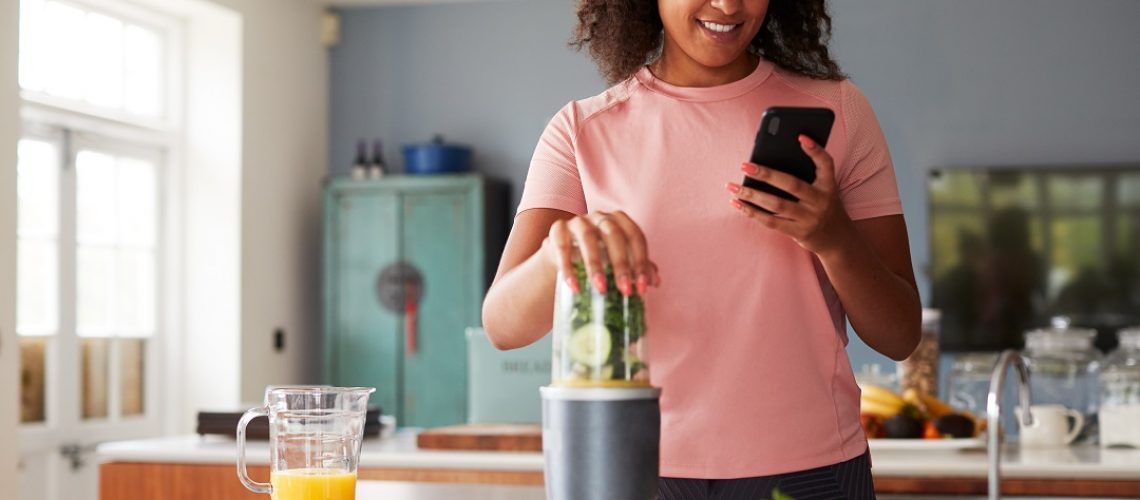 Woman Using Fitness Tracker To Count Calories