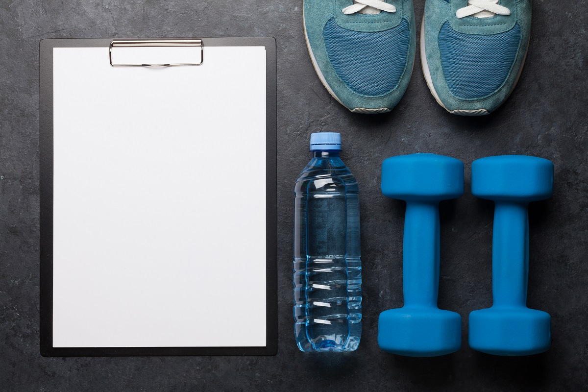 Clipboard, water bottle, weights, and sneakers
