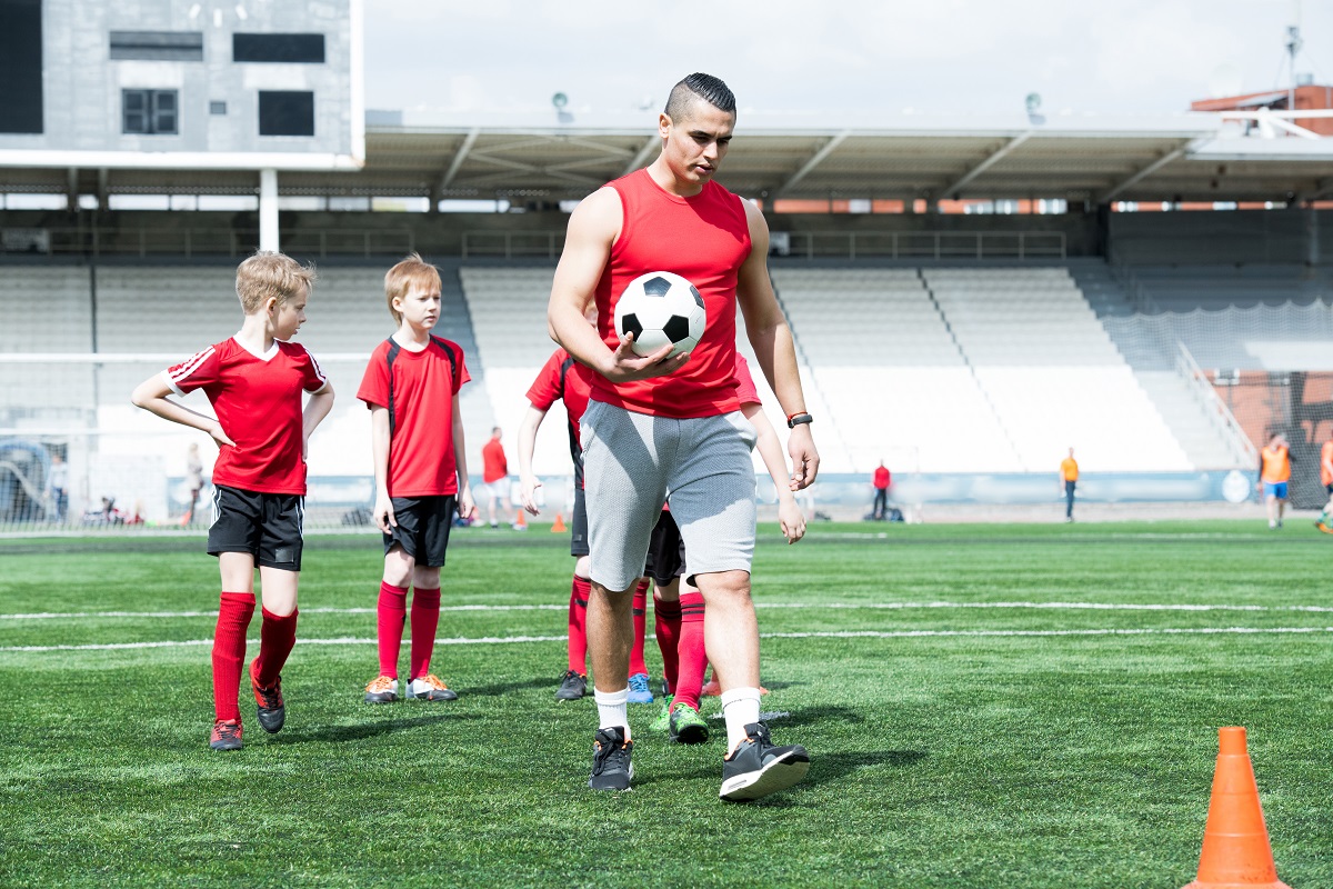 Soccer coach with players.