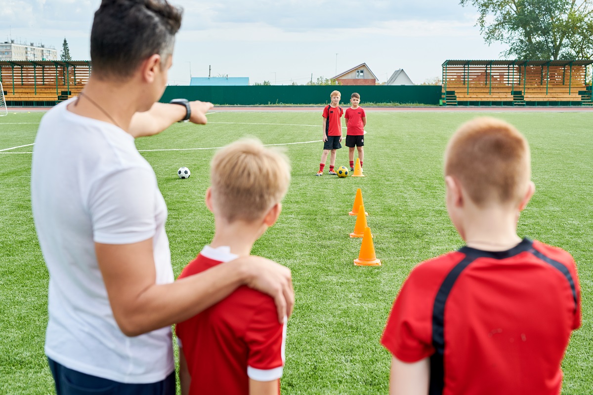 Coach with soccer players