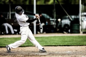 Baseball player swinging his bat at an incoming pitch