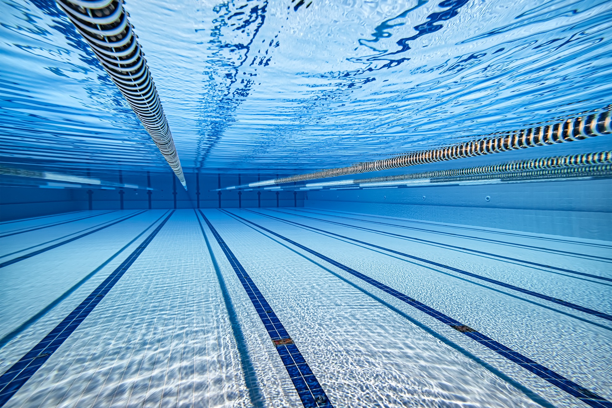 Olympic Swimming pool under water background.