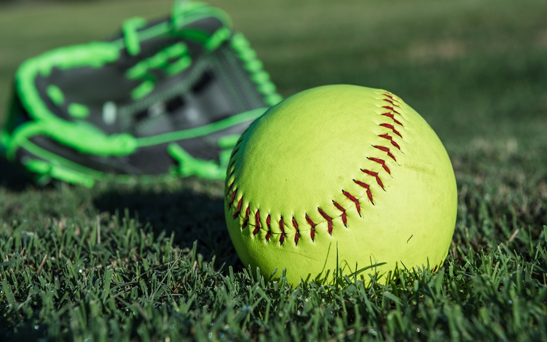 Softball and glove on a field