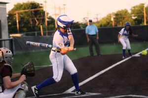 Softball player mid-swing