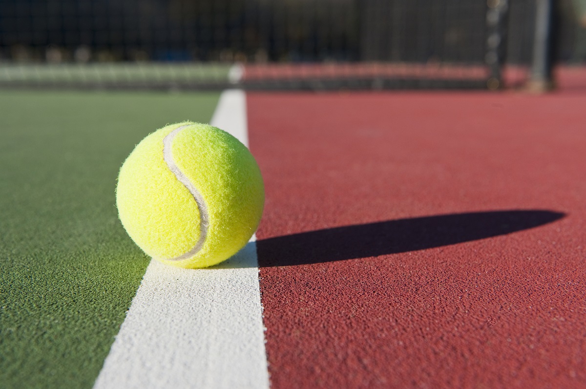 Tennis ball resting on the line