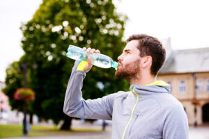 Runner enjoys water from a bottle