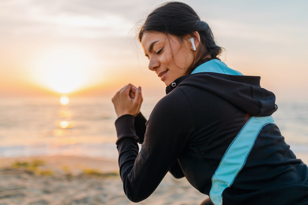 Exercising woman with earbuds