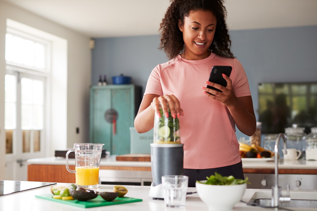 Woman Using Fitness Tracker To Count Calories